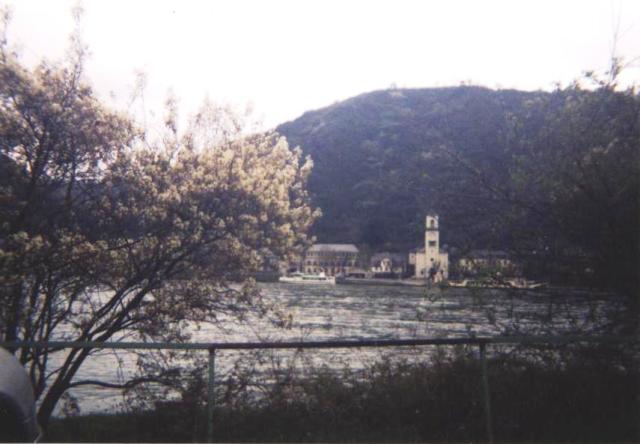 white tower on far side of Rhine river, hill behind, Germany