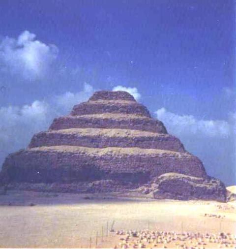 step pyramid in mid-ground, sky with fluffy clouds behind, flat desert in foreground